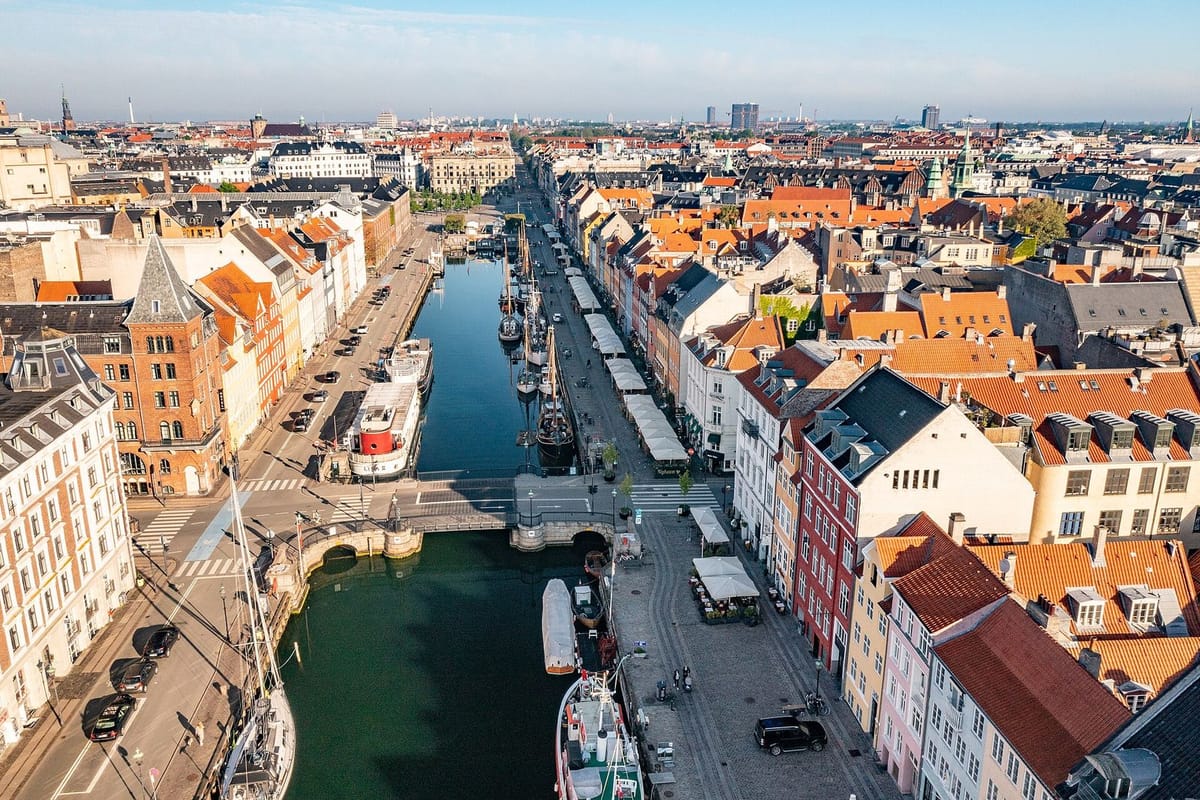 Rumah berwarna cerah dan perahu kayu di kanal Nyhavn, Kopenhagen